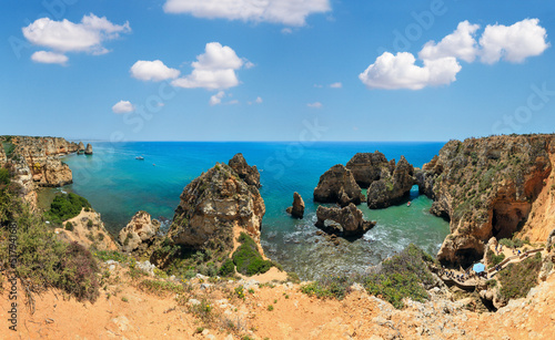 Ponta da Piedade (group of rock formations along coastline of Lagos town, Algarve, Portugal). People are unrecognizable.