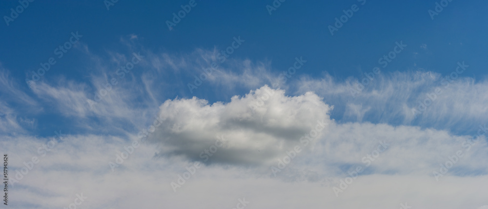 Cumulus cloud on the background of stratus clouds.