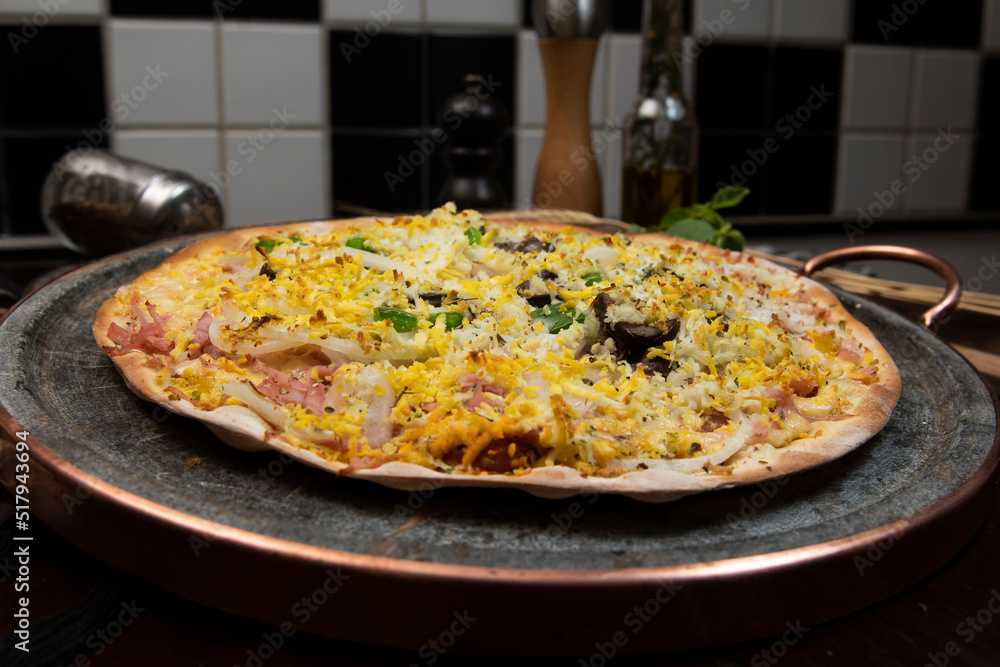 Brazilian Portuguese-style pizza with ham, egg, pepper, onion, mozzarella