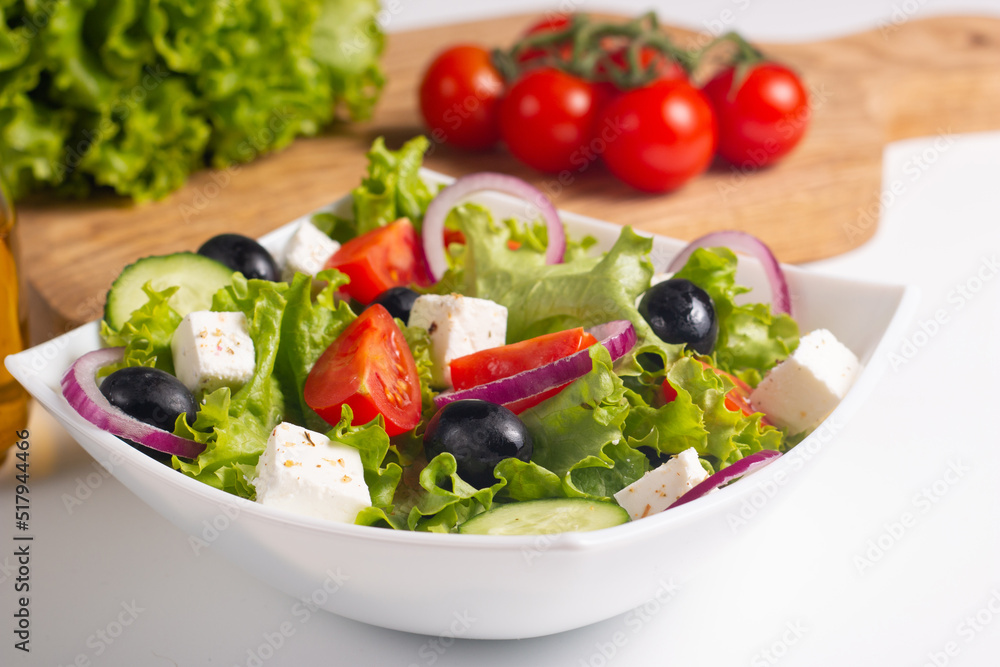 Greek salad with fresh tomatoes, cucumber, olives, feta cheese and red onion. Healthy and diet food concept. Greek salad with fresh tomatoes, cucumber, olives, feta cheese and red onion. Healthy and diet food concept.