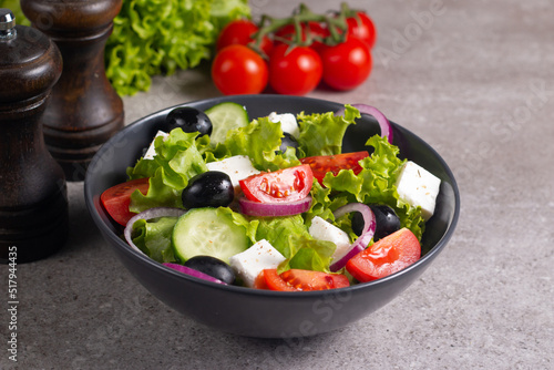 Greek salad with fresh tomatoes, cucumber, olives, feta cheese and red onion. Healthy and diet food concept.