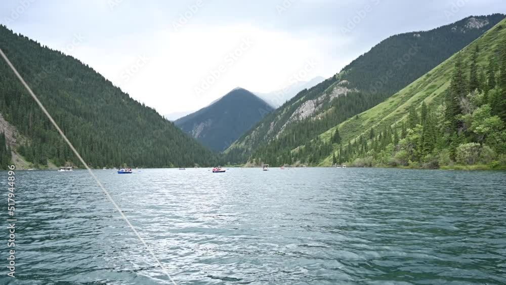 View from the catamaran to the mountain lake. View from the catamaran to the mountain lake.