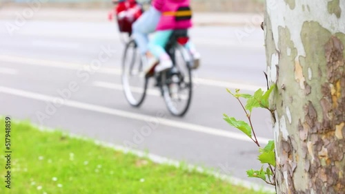 Happy family are riding a bicycle. Slow motion
