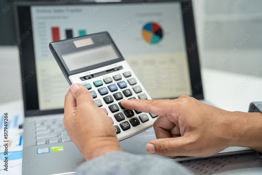 Asian accountant working and analyzing financial reports project accounting with chart graph in modern office, finance and business concept. Asian accountant working and analyzing financial reports project accounting with chart graph in modern office, finance and business concept.