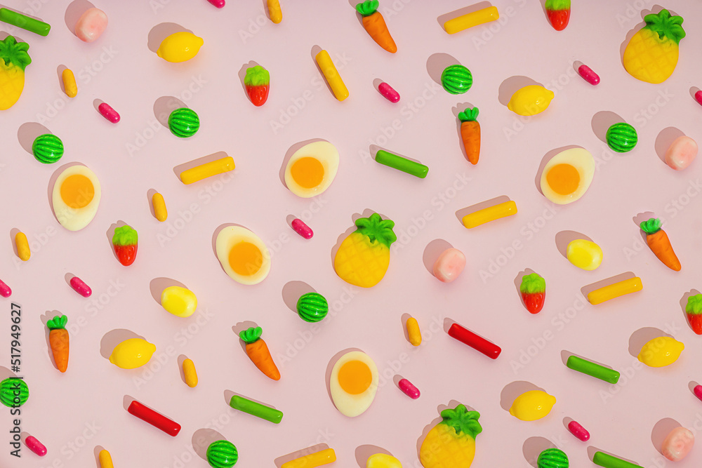 Trendy pattern of colorful candy, sweets, fruit gummies, sprinkles for party celebration design over pink background. Creative greeting card about food ideas. Sugar problem with kids eating.. Trendy pattern of colorful candy, sweets, fruit gummies, sprinkles for party celebration design over pink background. Creative greeting card about food ideas. Sugar problem with kids eating..