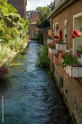 Fototapeta Naklejka Na Ścianę i Meble -  Small river flows throughout beautiful French village Veules-les-Roses, old houses and flowers