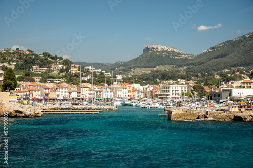 Panoramic view on cliffs, blue sea, beach, houses, streets and old fisherman's harbour with lighthouse in Cassis, Provence, France © barmalini