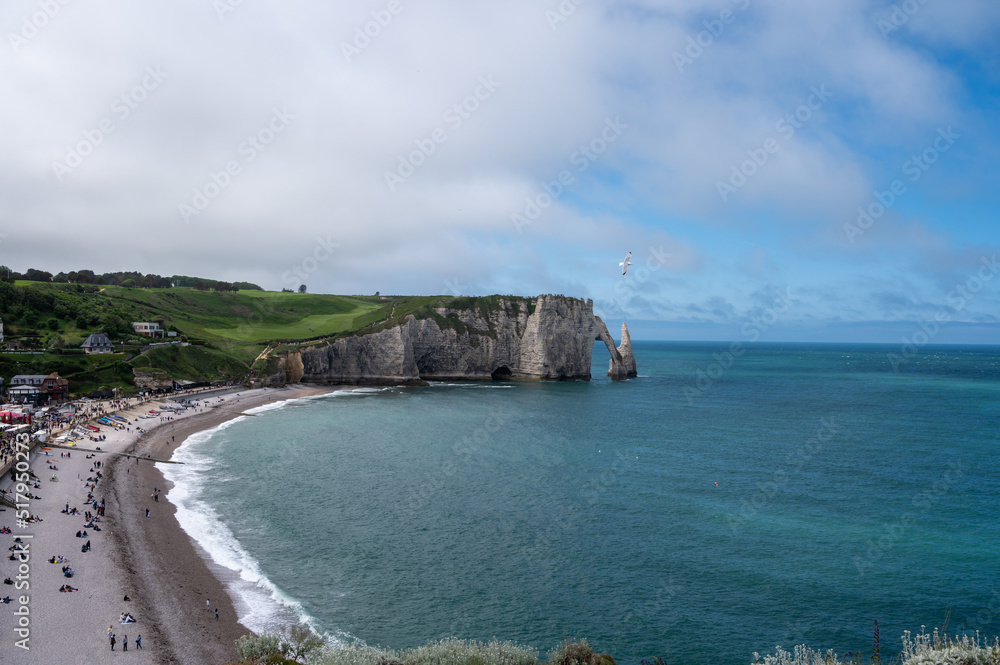 Panoramic view on chalk cliffs and Porte d'Aval arch in Etretat, Normandy, France. Tourists destination. Panoramic view on chalk cliffs and Porte d'Aval arch in Etretat, Normandy, France. Tourists destination.