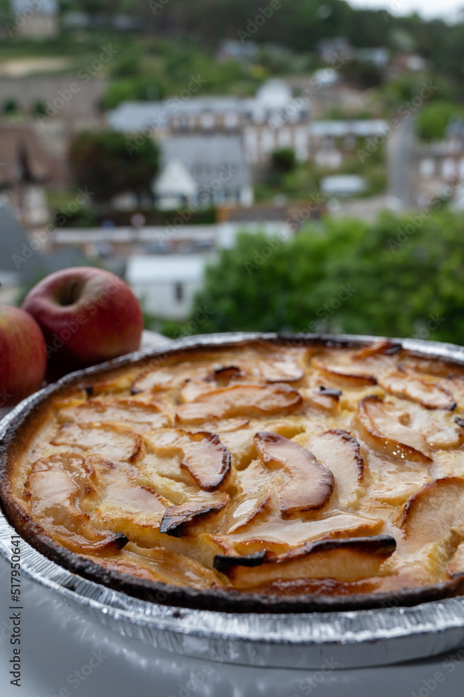Tasty sweet French dessert, baked apple cake and view on old houses of