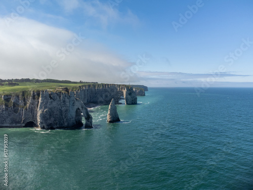 Aerial panoramic view on chalk cliffs and Porte d'Aval arch in Etretat, Normandy, France. Tourists destination.