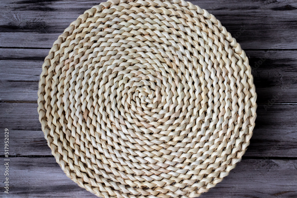 Hyacinth wicker round kitchen rug on a wooden table. Hyacinth wicker round kitchen rug on a wooden table.