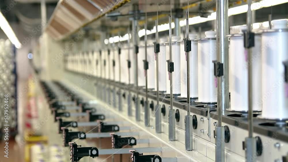 Textile Industry - Yarn Thread Running In The Machine. Automated Yarn Production In Modern Textile Plant. Cotton Yarn Making Machine. Textile Industry - Yarn Thread Running In The Machine. Automated Yarn Production In Modern Textile Plant. Cotton Yarn Making Machine.