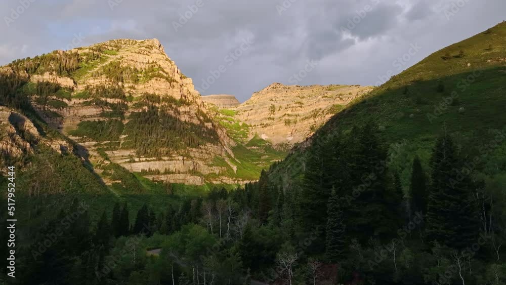 Aerial view flying over forest at Aspen Grove at sunrise as Timpanogos Mountain lights up. Aerial view flying over forest at Aspen Grove at sunrise as Timpanogos Mountain lights up.