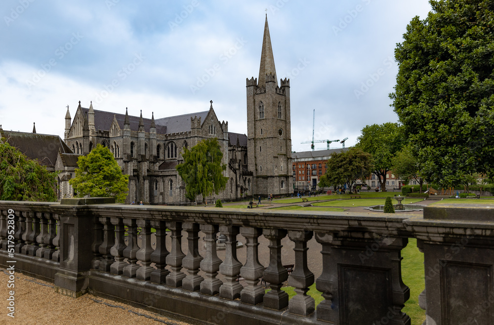 Obraz premium St Patrick's Cathedral in Dublin, Ireland seen from the observation platform next to it covered in gravel