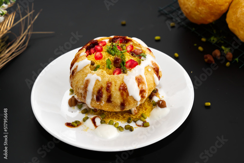 Raj Kachori - popular Indian chaat which crispy fried shells (kachori) filled with potatoes, boiled moong dal, yogurts, spices, chutneys and topped with various garnishes! photo