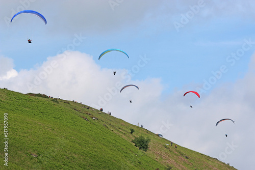 Paragliders flying above the ridge at Pandy, Wales photo