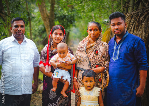 South asian family picture . happy bangladeshi hindu family in a village outdoor environment.  photo