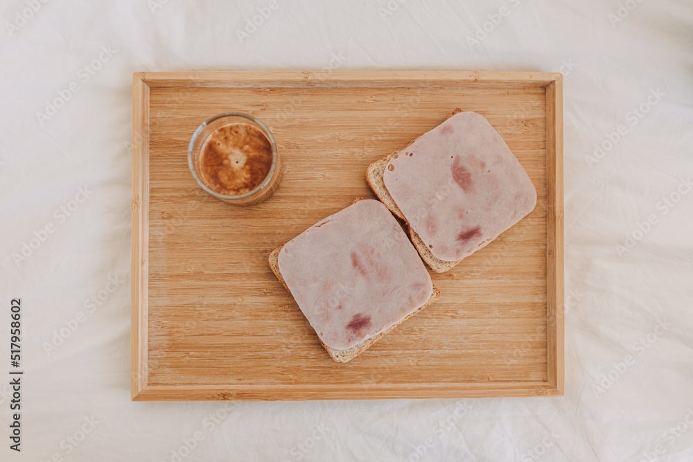 Top view of sandwich ham with espresso coffee served on white bed. Top view of sandwich ham with espresso coffee served on white bed.
