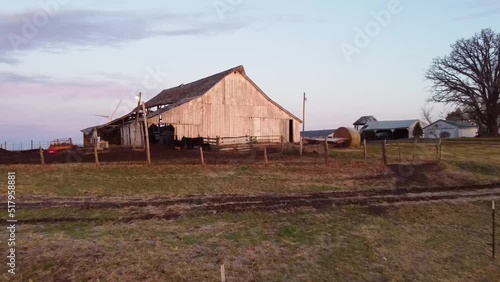 Missouri barn with wind turbines in the background at dawn
