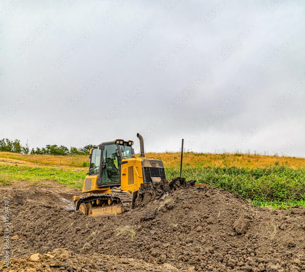 Preparation for construction. Heavy bulldozer standing on construction site. Preparation for construction. Heavy bulldozer standing on construction site.