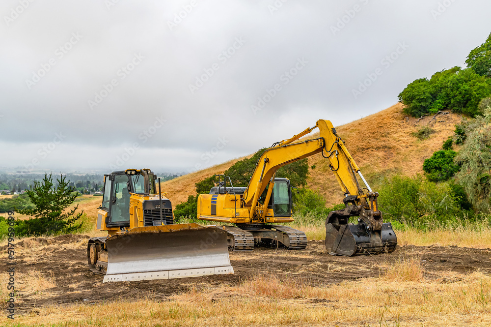 Construction machinery. A bulldozer and an excavator are clearing the construction site. Construction machinery. A bulldozer and an excavator are clearing the construction site.