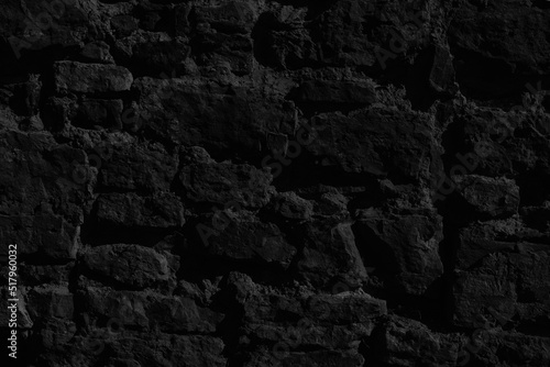 Dark background of black stones texture. Pattern of black stones