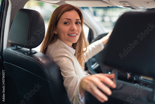 Happy business woman driver sitting in car holding to steering wheel. © Dexon Dee