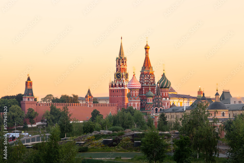 St. Basil's Cathedral, Kremlin wall and towers above park foliage at sunrise, Moscow, Russia