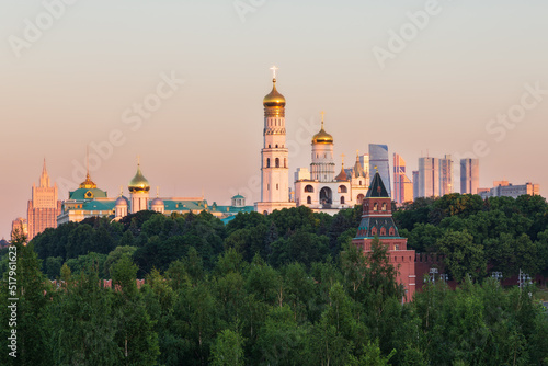 Skyscrapers, bell towers and churches, Kremlin wall and towers above park foliage, Moscow, Russia