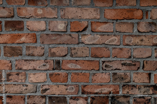 old wall with red bricks and concrete. Abstract background texture.