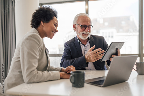 Senior businessman explaining strategy to female coworker