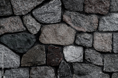 close-up on fragment of wall with masonry of rough gray stones Fototapet