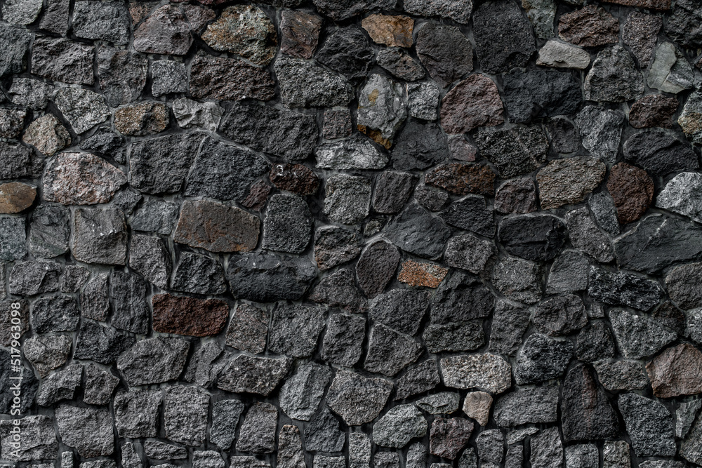 view of wall with masonry of various stones. Background and texture of stone wall surface view of wall with masonry of various stones. Background and texture of stone wall surface