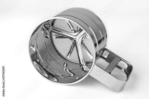 Metal flour sifter isolated on white background. Close-up