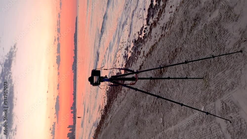Video of a camera on a tripod taking pictures at sunrise on the beach, because it is the photography day. Video of a camera on a tripod taking pictures at sunrise on the beach, because it is the photography day.