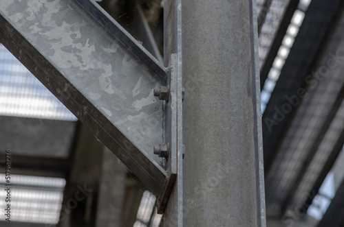 beam architecture: detail of a structure built with steel beams joined with bolting to support a staircase for emergency exits in a public building.