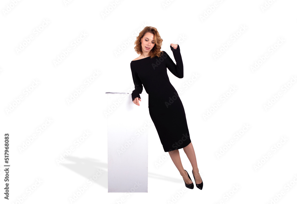 Beautiful white business woman with red hair in a black dress and high heels shoes on the white background Beautiful white business woman with red hair in a black dress and high heels shoes on the white background