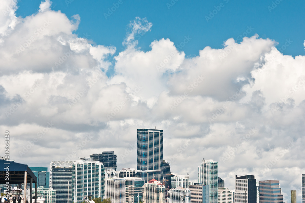 front view, far distance of the tropical, Miami, Florida skyline, at mid afternoon light with large white clouds