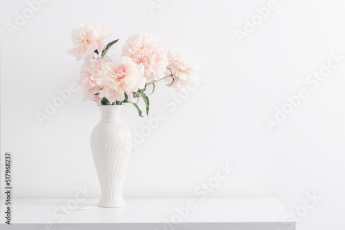 Fototapeta Naklejka Na Ścianę i Meble -  pink peonies in ceramic white vase in white interior