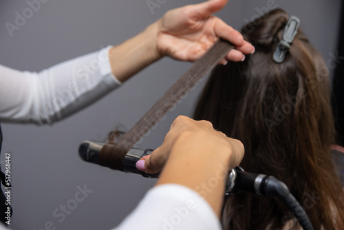 a hairdresser makes a woman's hair in a spa salon 