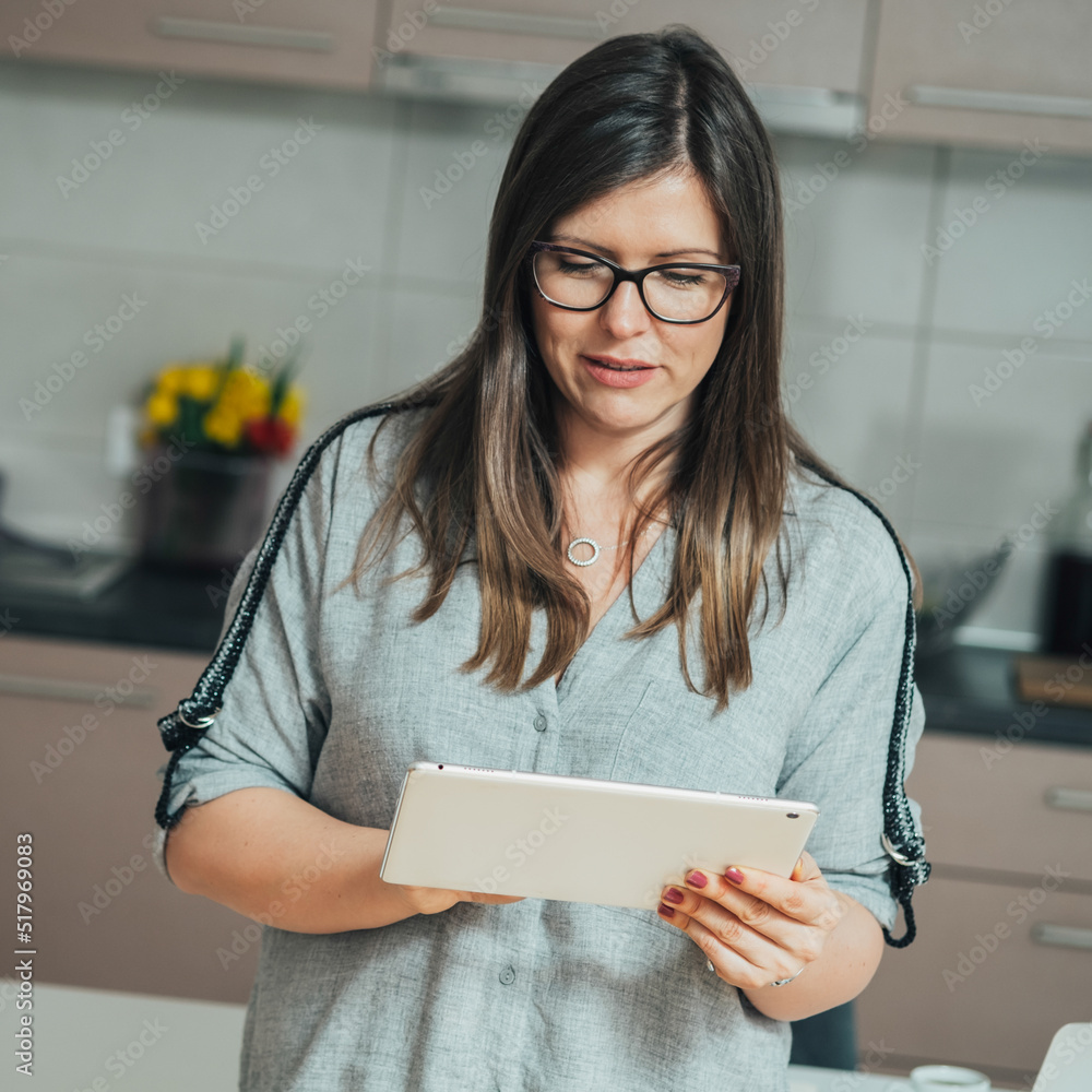 © Tijana - Casual Businesswoman Using A Digital Tablet At Home © Tijana - Casual Businesswoman Using A Digital Tablet At Home