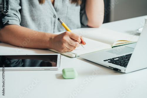 Close Up Photo Of Woman Hands Writing Notes In A Notebook At Home Office Table