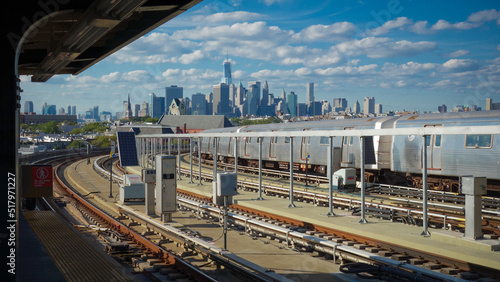 Train station platform with Manhattan skyline photo