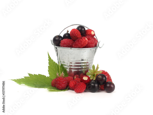 Ripe raspberries, strawberries and black currants on a white background.