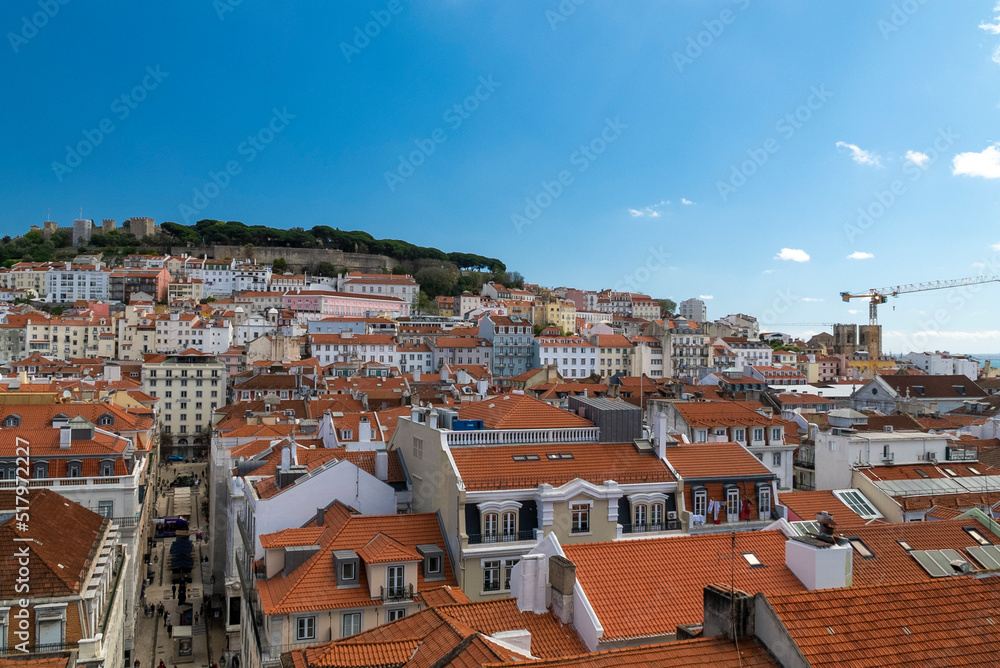 Lisboa, Portugal. April 10, 2022: Alfama neighborhood on a summer afternoon and San Jorge castle.