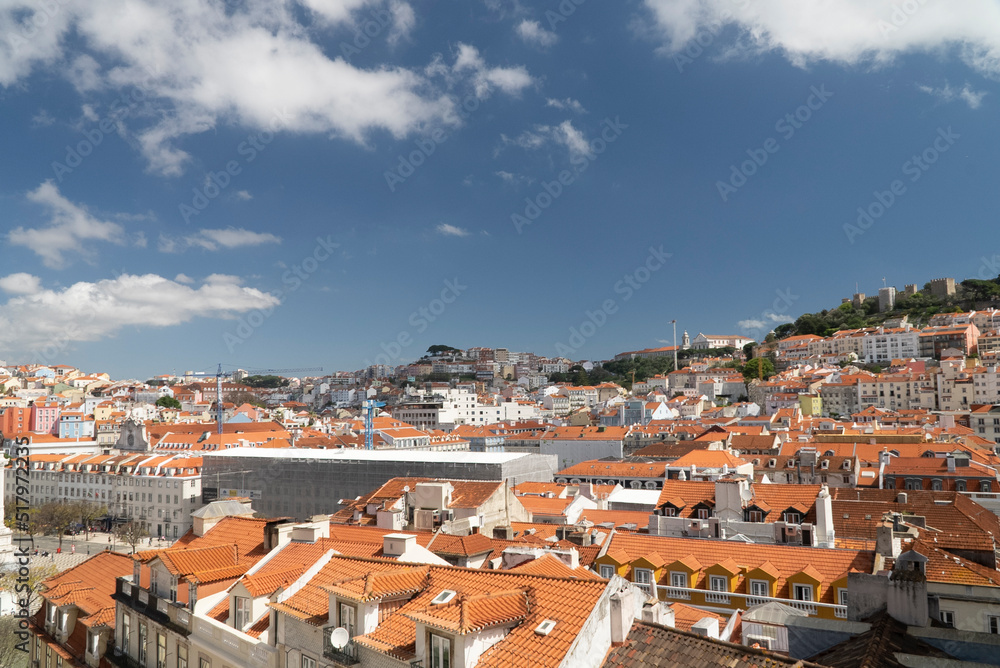 Naklejka premium Lisboa, Portugal. April 10, 2022: Alfama neighborhood on a summer afternoon and San Jorge castle.
