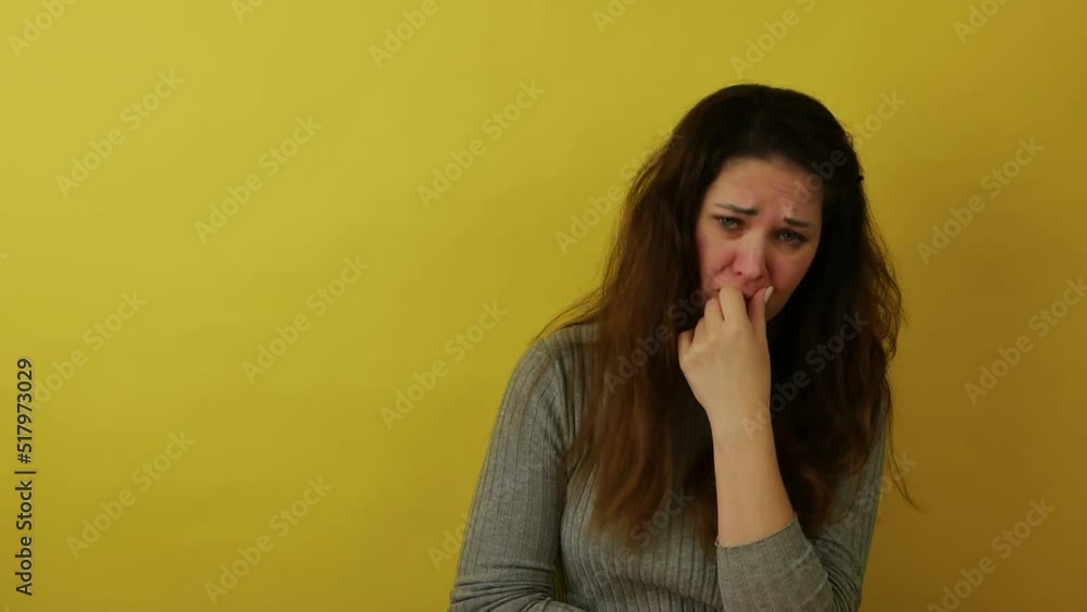 An attractive woman in a gray sweater with long hair is very angry and gesticulates with her hands. Person's facial expressions, emotions and feelings. Body language. An attractive woman in a gray sweater with long hair is very angry and gesticulates with her hands. Person's facial expressions, emotions and feelings. Body language.