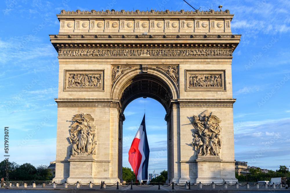 FRANCE - PARIS - CHAMPS ELYSEES - JULY 14 2022. Early in the morning, the French flag is raised under the Arc de Triomphe for the Bastille Day. - obrazy, fototapety, plakaty 