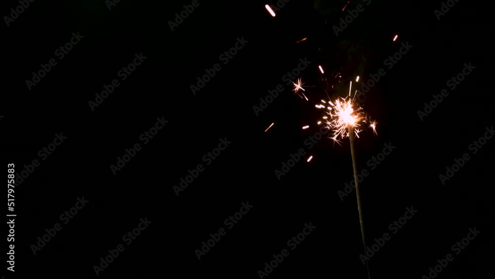 A Full HD Slow motion video of a sparkler burning and sparking isolated on a black background with copy space. perfect for event or birthday or e-vite A Full HD Slow motion video of a sparkler burning and sparking isolated on a black background with copy space. perfect for event or birthday or e-vite