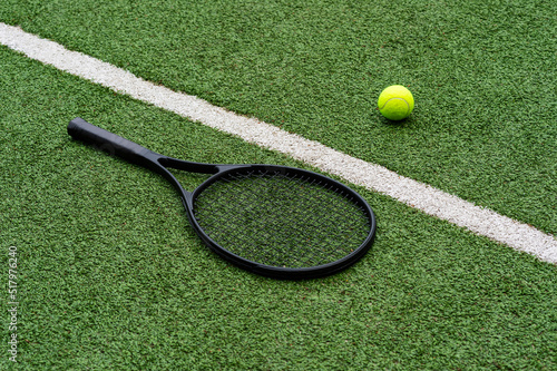 Top view of tennis rackets and ball of green grass. Horizontal sport poster, greeting cards, headers, website © Augustas Cetkauskas